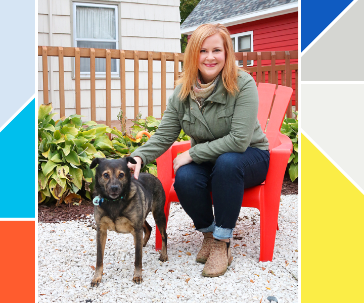 Woman sitting on a red chair with her dog