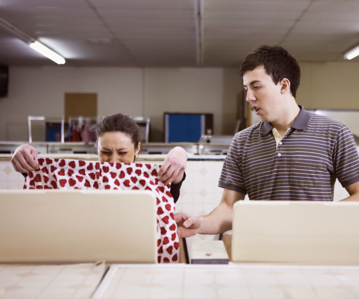 Coworkers grimacing over gross pants